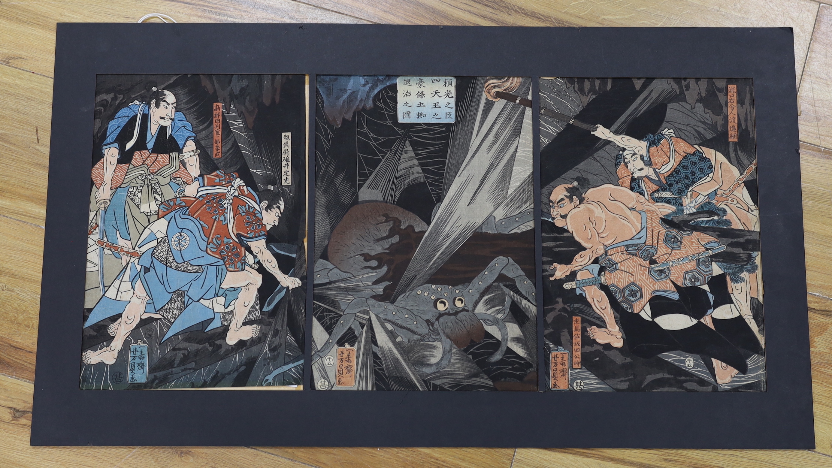 Utagawa Yoshikazu (act.1850-1870) Japanese woodblock triptych, The Earth Spider Slain by Raiko's Retainers, various inscriptions verso including publ. 1858, mounted, framed, overall 81 x 46cm